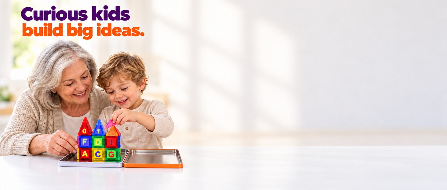 Curious kids build big ideas. A grandmother and grandson build a tile house together on the open tin.